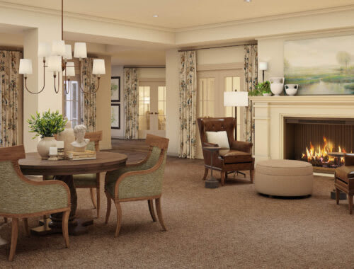 A cozy and elegantly designed living room featuring a fireplace, dining table, and classic furniture.
