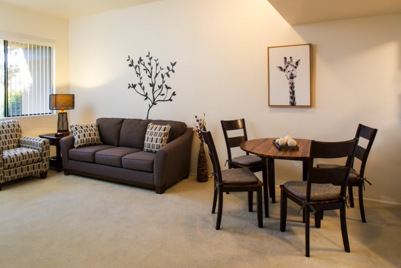 A modern living room with a sofa and dining area.