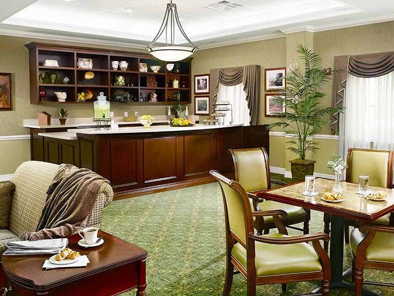 A modern living space featuring a kitchen, dining area, and elegant furniture.