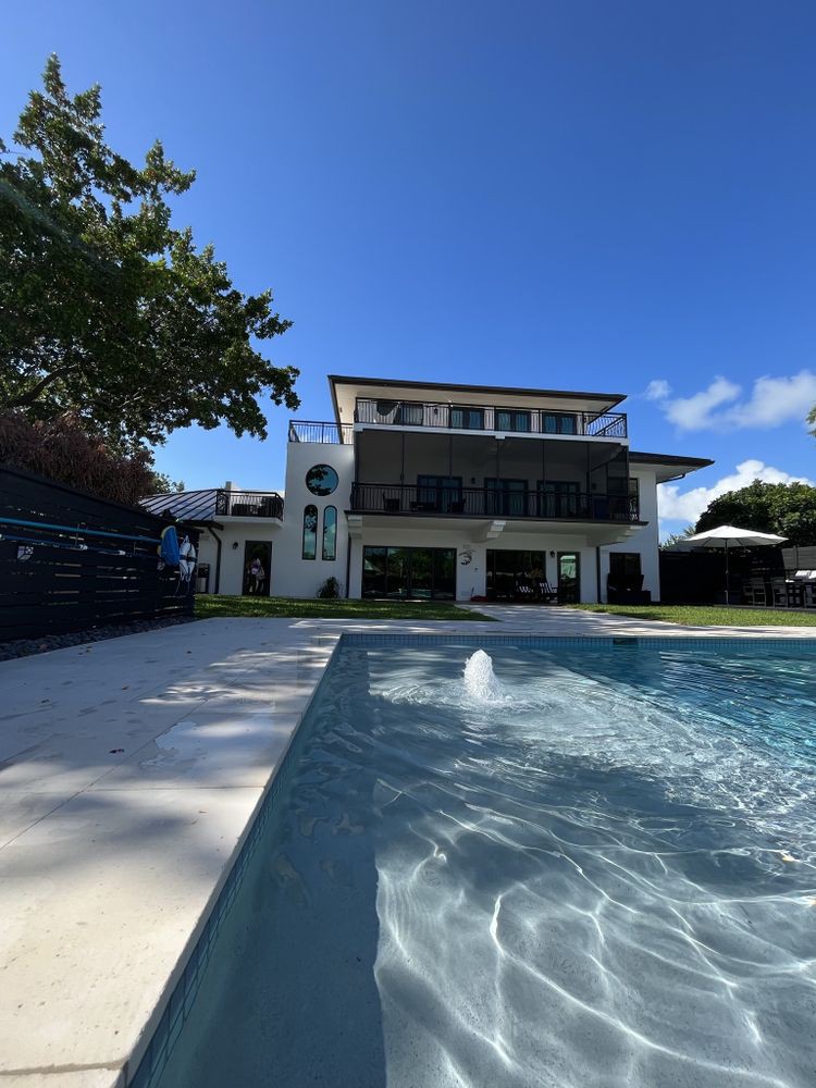 A modern luxury house with a swimming pool on a sunny day.