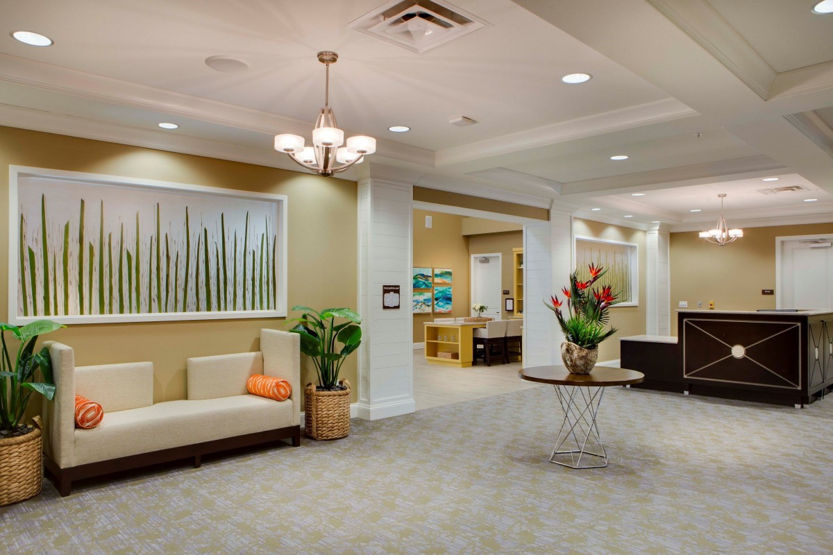 A modern lobby with elegant seating, artwork, and decorative plants.