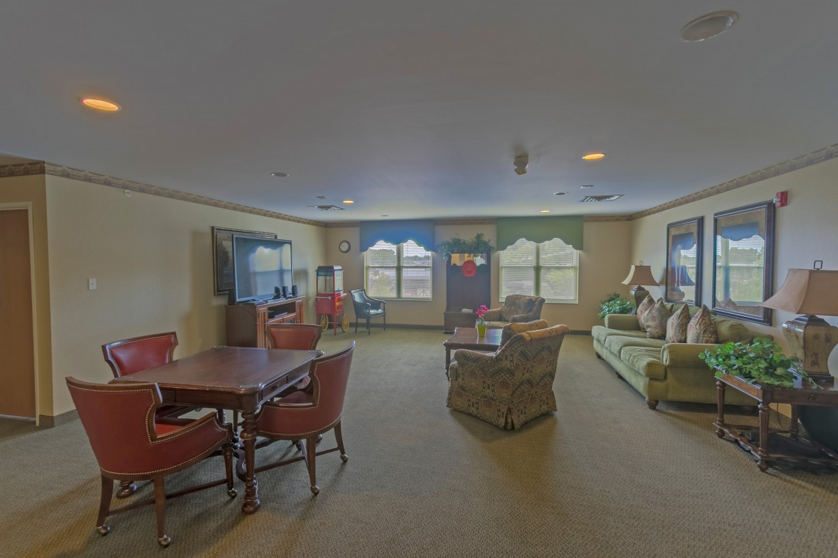 A spacious living room with comfortable seating and large windows.