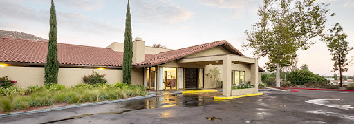 A modern residential building entrance with a welcoming driveway.