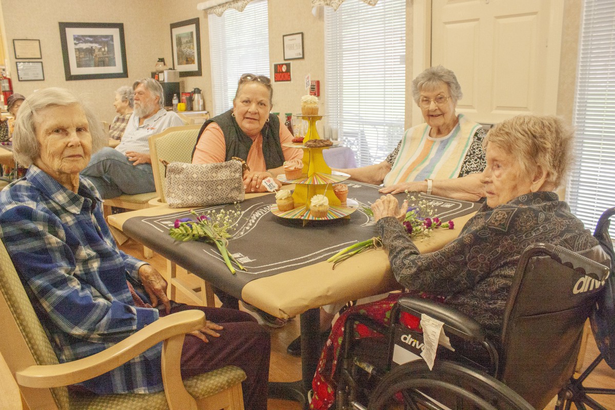 A group of elderly individuals enjoying a social gathering indoors.