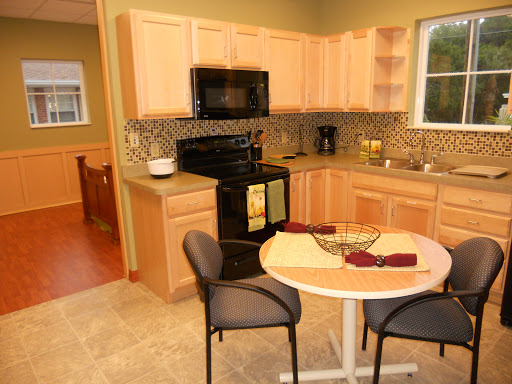 A cozy kitchen featuring modern appliances and a small dining area.