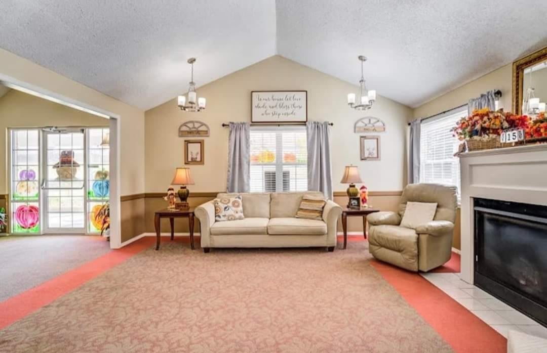 A cozy living room featuring a sofa, armchair, and warm decor.