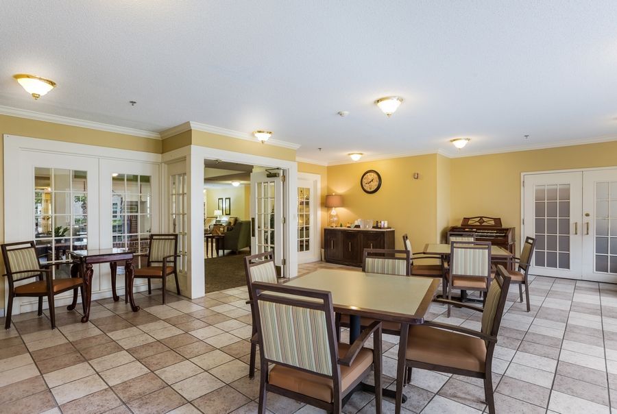 A cozy dining area with tables, chairs, and warm lighting.