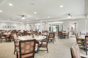 Spacious dining area with numerous tables and chairs arranged for guests.