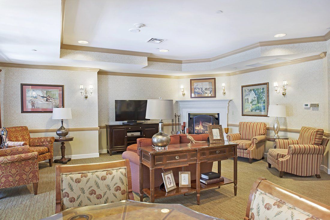 A cozy living room with comfortable seating, a television, and a fireplace.