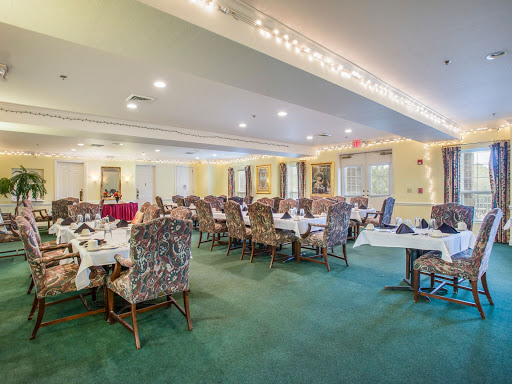 A spacious dining room with elegantly arranged tables and comfortable seating.