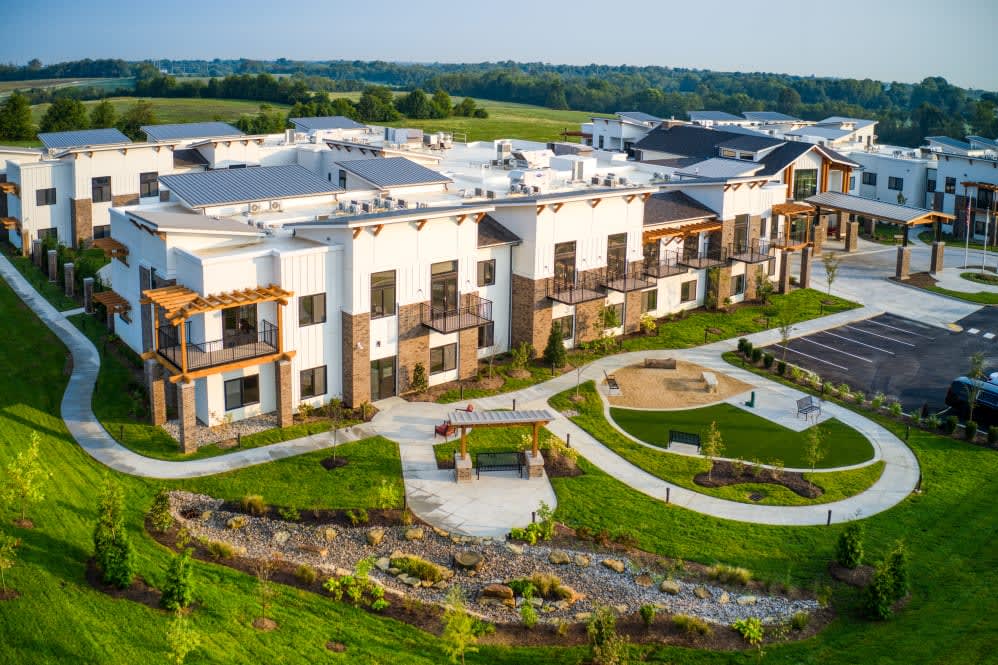 A modern apartment complex with landscaped gardens and outdoor spaces.