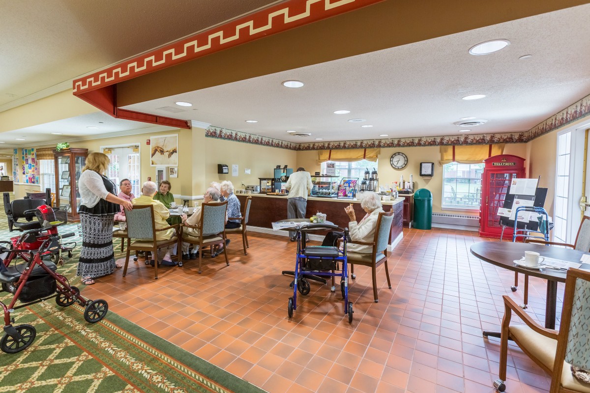 A cozy cafe where people are seated, enjoying their time and interacting with each other.