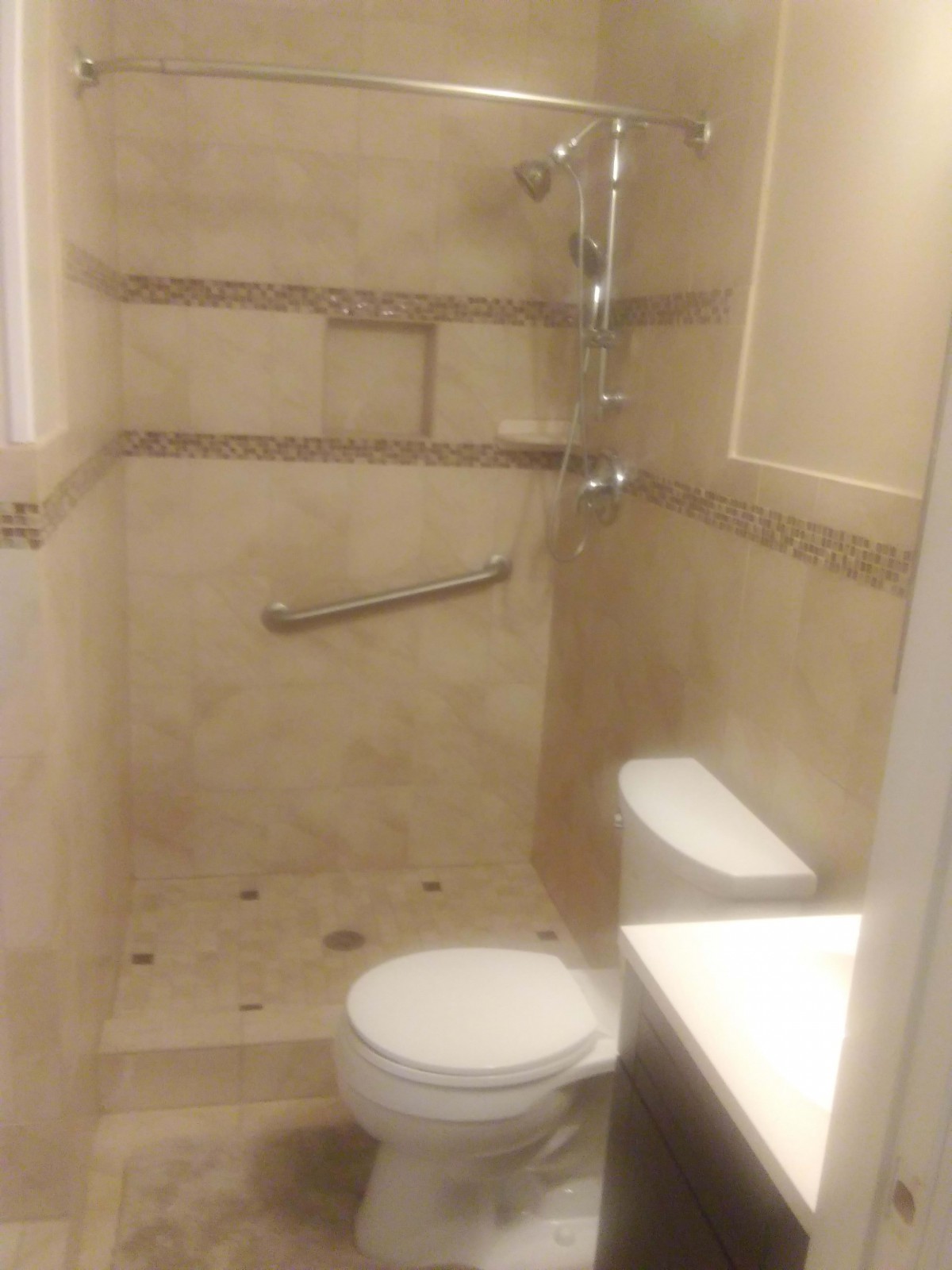 Compact bathroom with a shower and toilet.