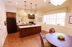 A modern kitchen with an island counter and dining area.