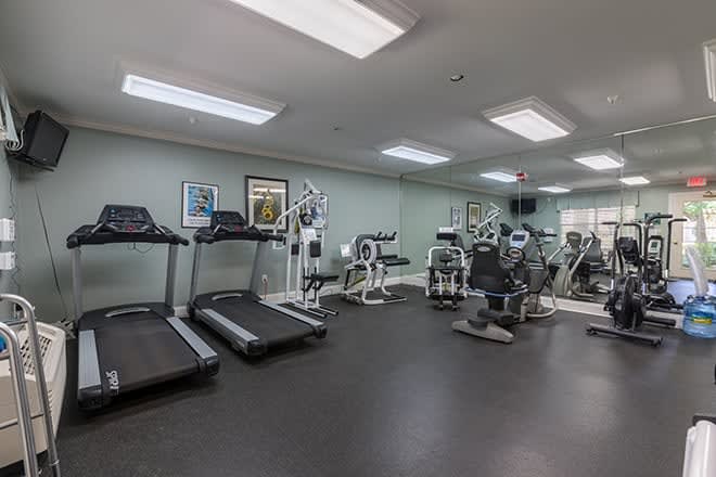 A well-equipped gym with treadmills and various exercise machines.