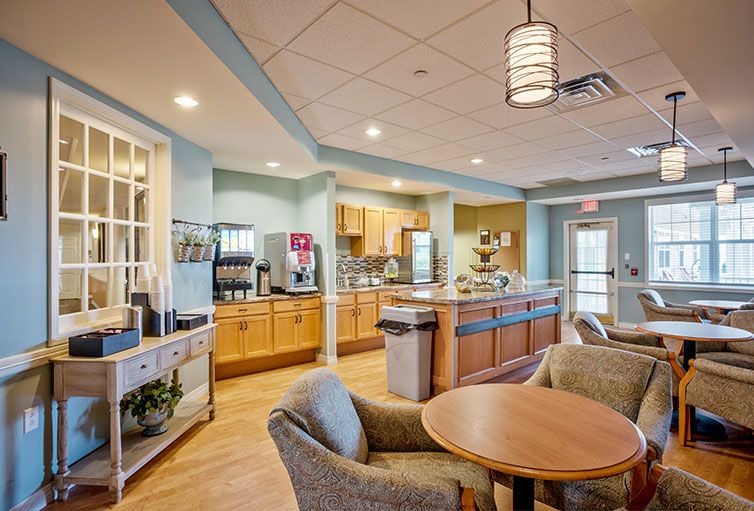 A cozy and modern cafe interior with a kitchen and dining area.