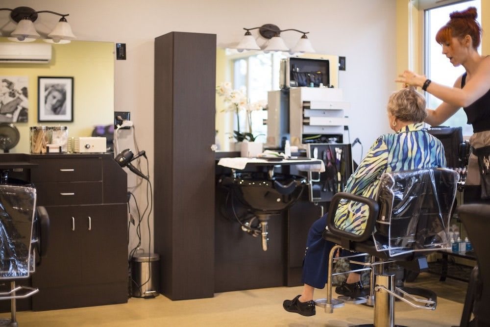 A person sitting in a hair salon getting their hair done.