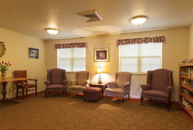 A cozy living room with a seating area and warm lighting.