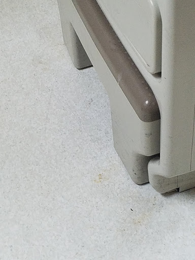 A close-up view of the corner and base of a storage cabinet.
