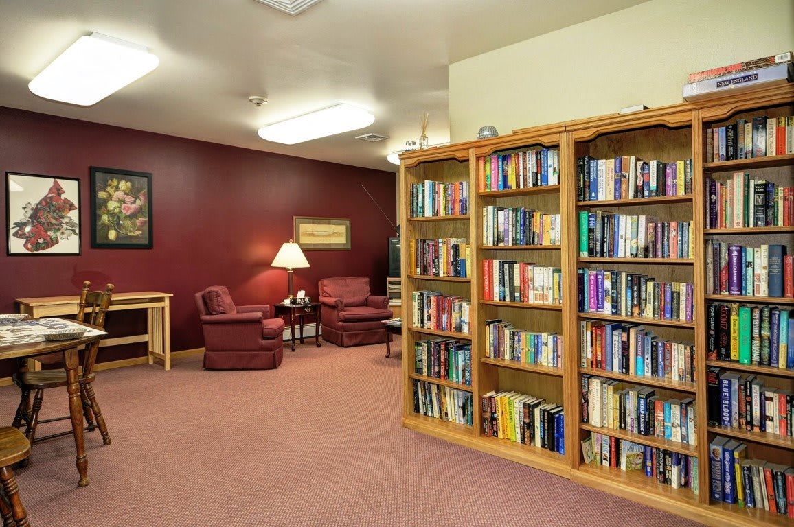 A cozy library area with bookshelves and comfortable seating.