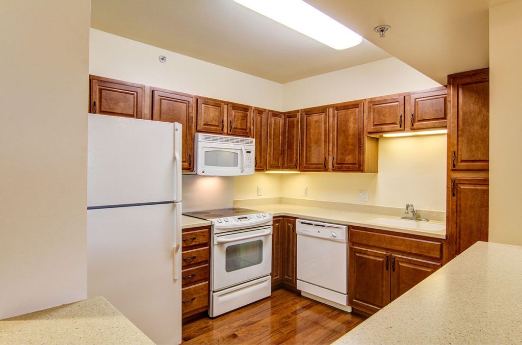 A cozy kitchen with wooden cabinets and modern appliances.