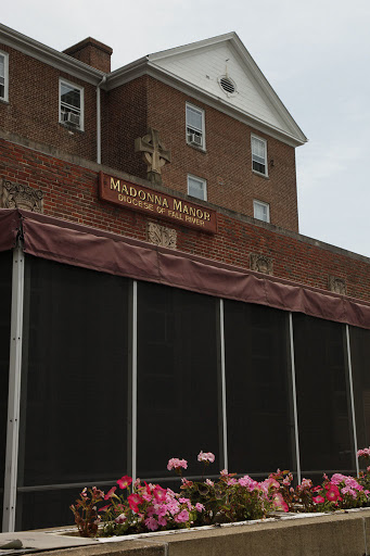 Facade of a historical building with a covered entrance.