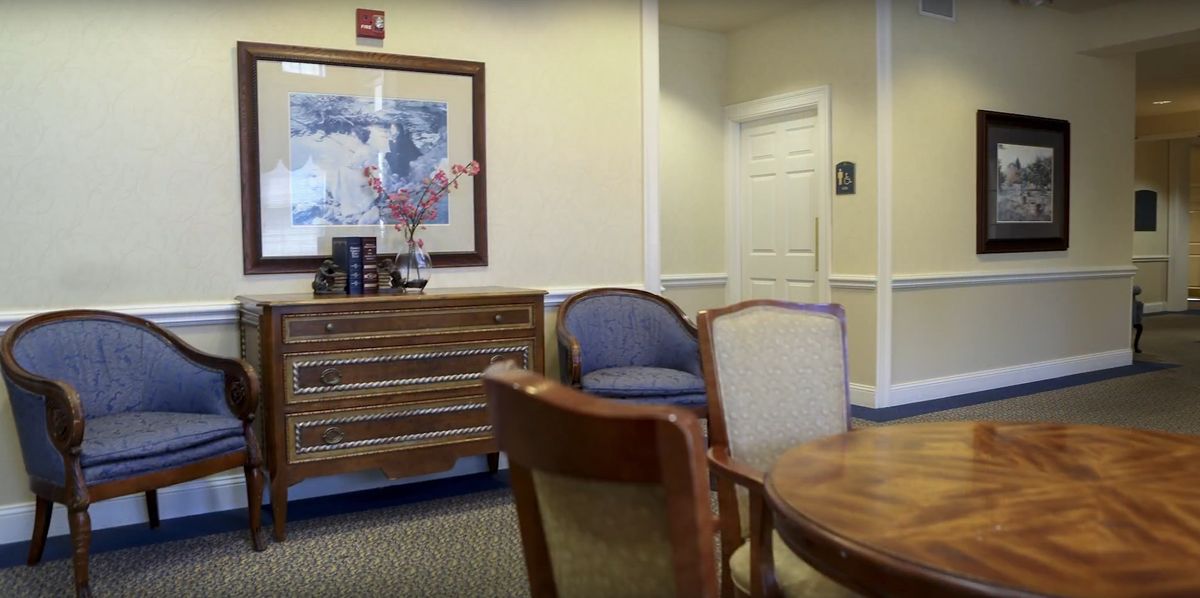 A well-appointed waiting room with comfortable chairs and a decorative table.