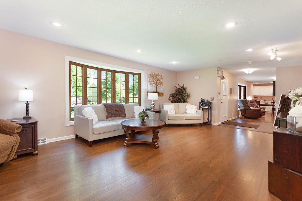 Spacious living room with hardwood floors and comfortable seating arrangement.