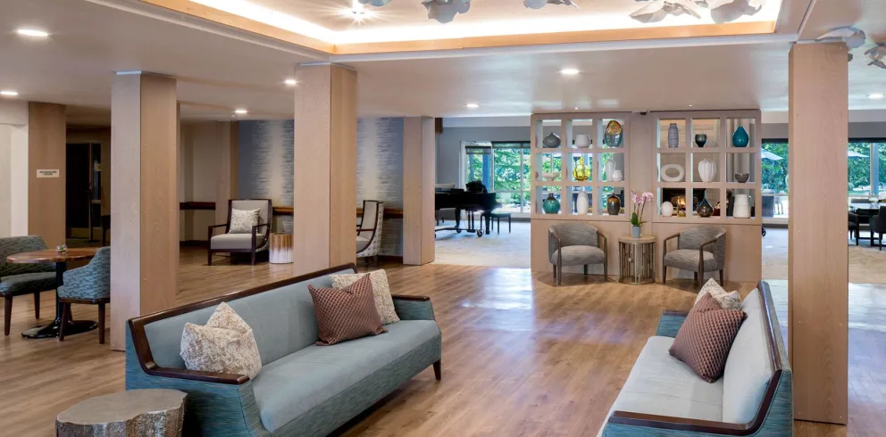 A modern lounge area featuring a piano, comfortable seating, and stylish decor.