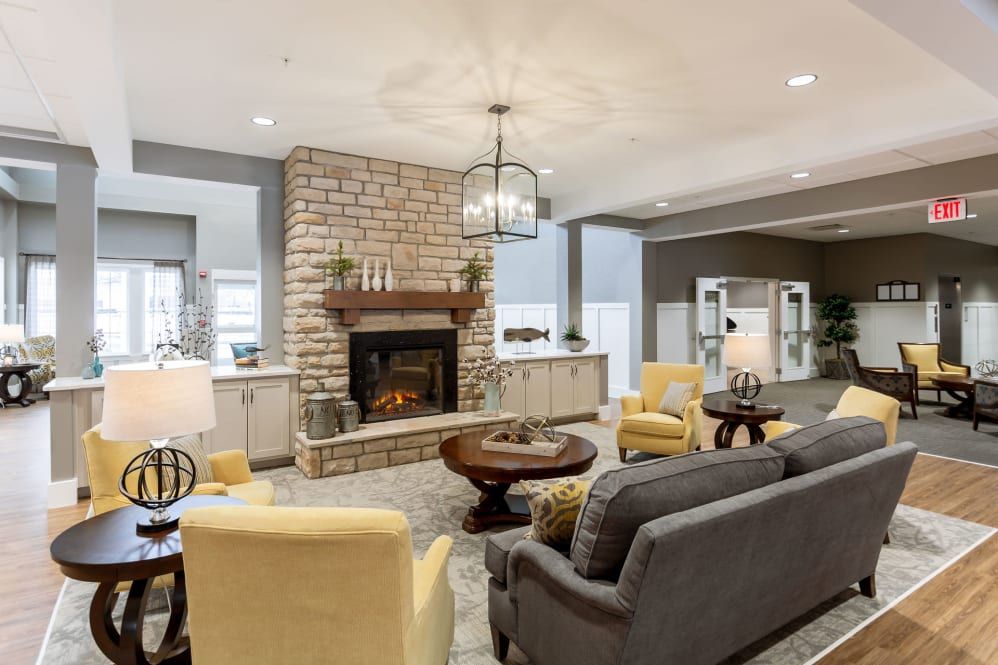 A cozy living room with a central fireplace, comfortable seating, and stylish decor.