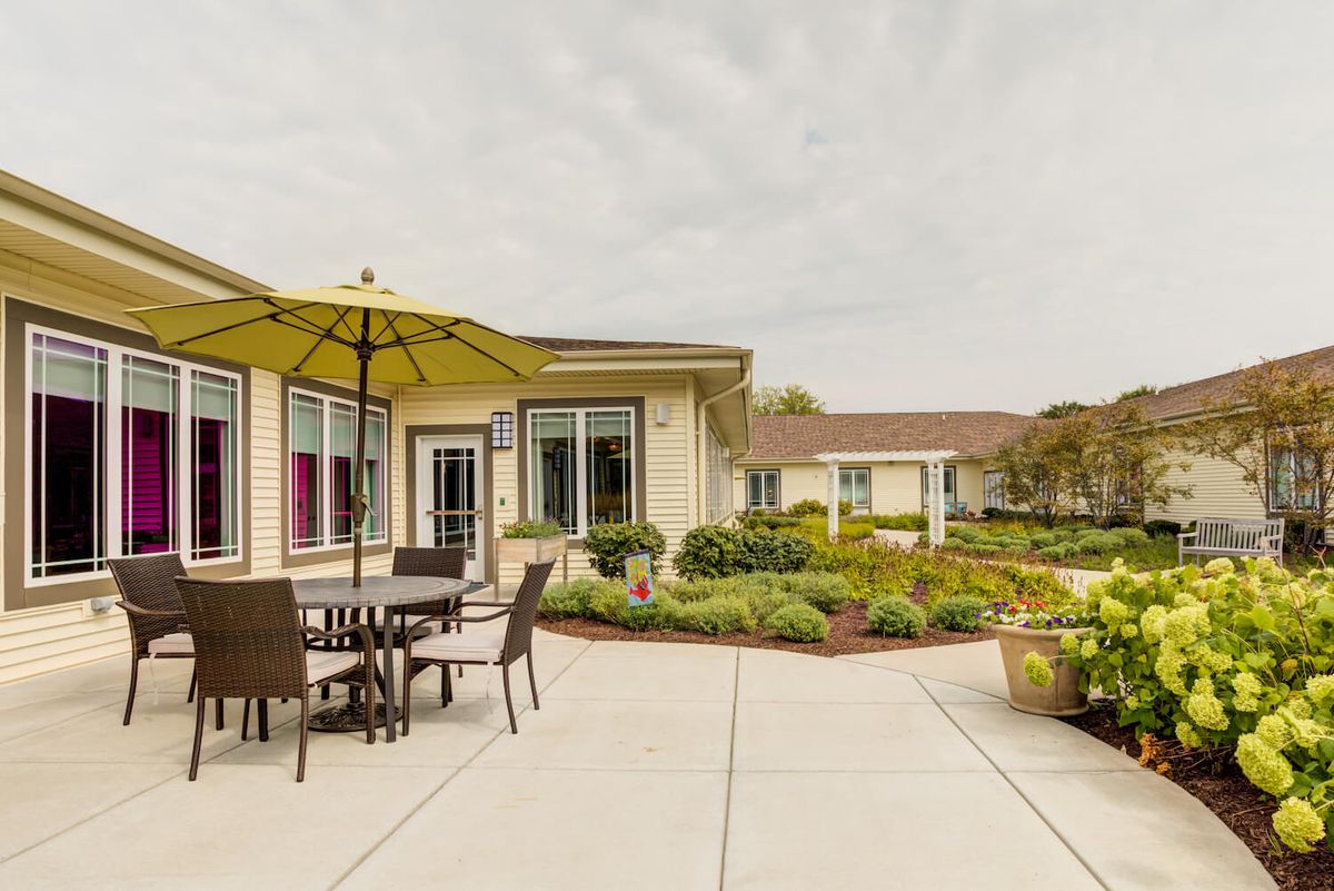 A landscaped patio area with outdoor seating and umbrellas.