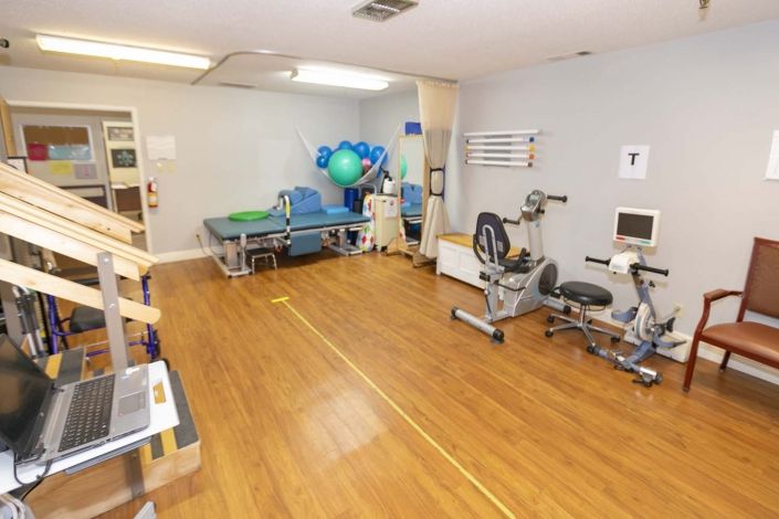 A rehabilitation clinic equipped with exercise machines and therapy tools.