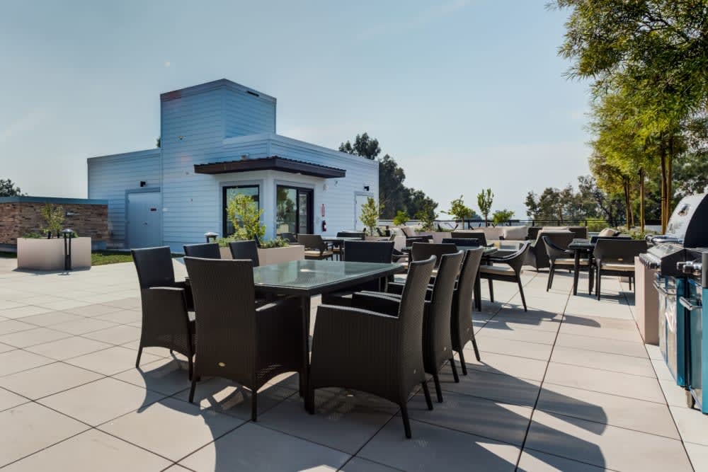 An outdoor patio with a modern dining set under a clear sky.