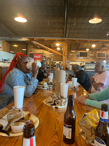 A joyful gathering around a table enjoying food and drinks.