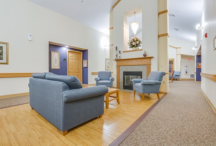 A cozy living room with comfortable seating around a fireplace.