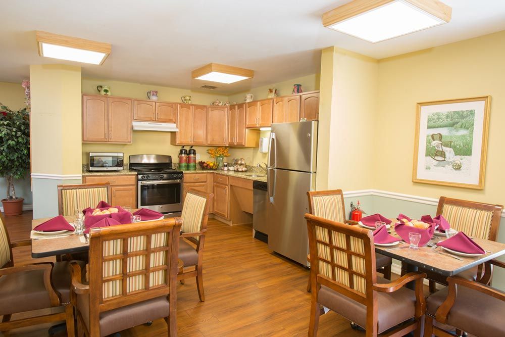 A cozy kitchen and dining area with modern appliances and wooden furniture.