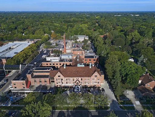 An aerial view showcasing a mix of historic buildings surrounded by lush greenery.