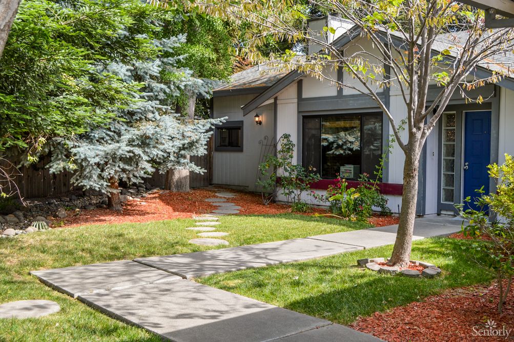 A charming house with a well-manicured front yard and garden path.