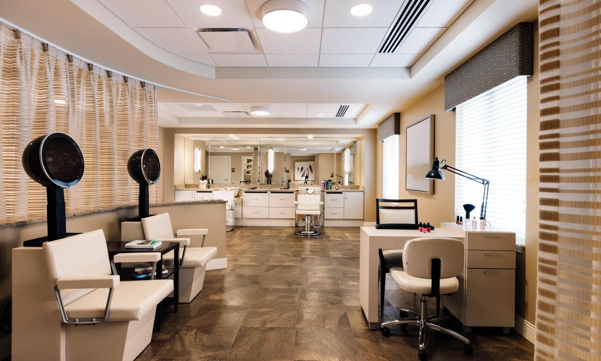 A modern beauty salon interior with stylish furnishings and bright lighting.