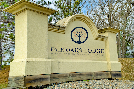 Signage of Fair Oaks Lodge, welcoming guests to a serene outdoor retreat.