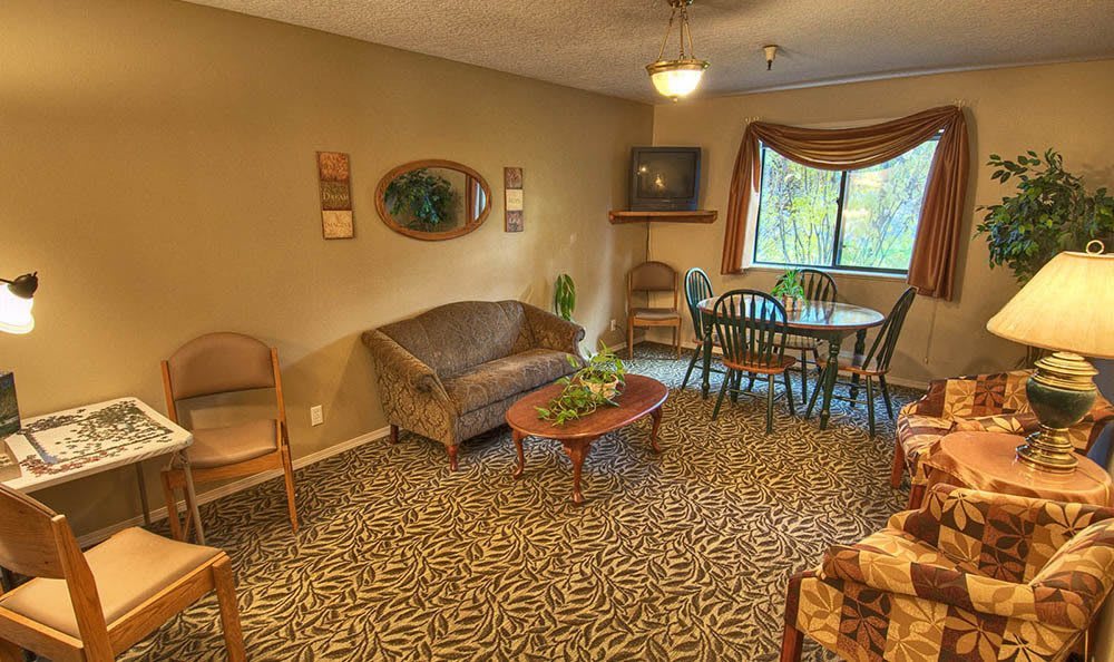 A cozy living room featuring a couch, dining area, and decorative elements.