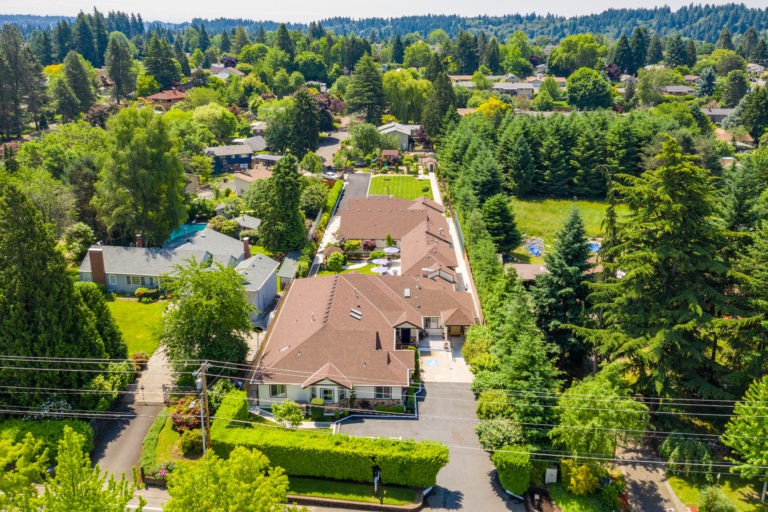 Aerial view of a residential neighborhood surrounded by lush greenery.