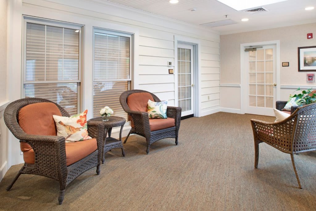 A cozy waiting room with wicker chairs and soft lighting.