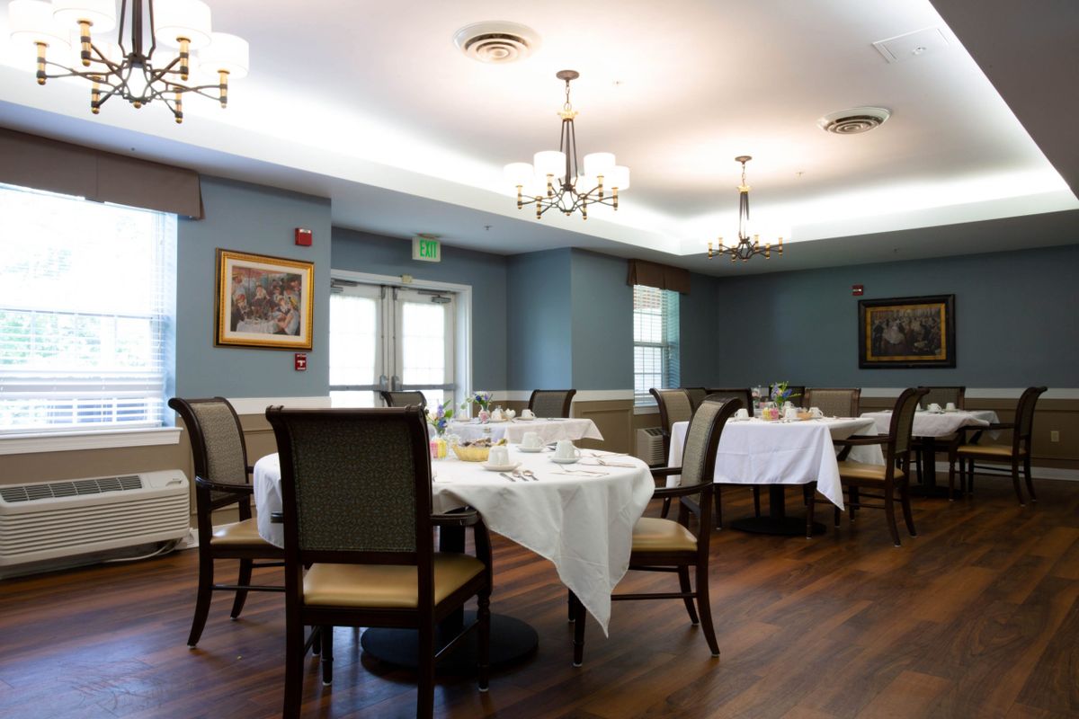 An elegant dining room with neatly arranged tables and chairs.