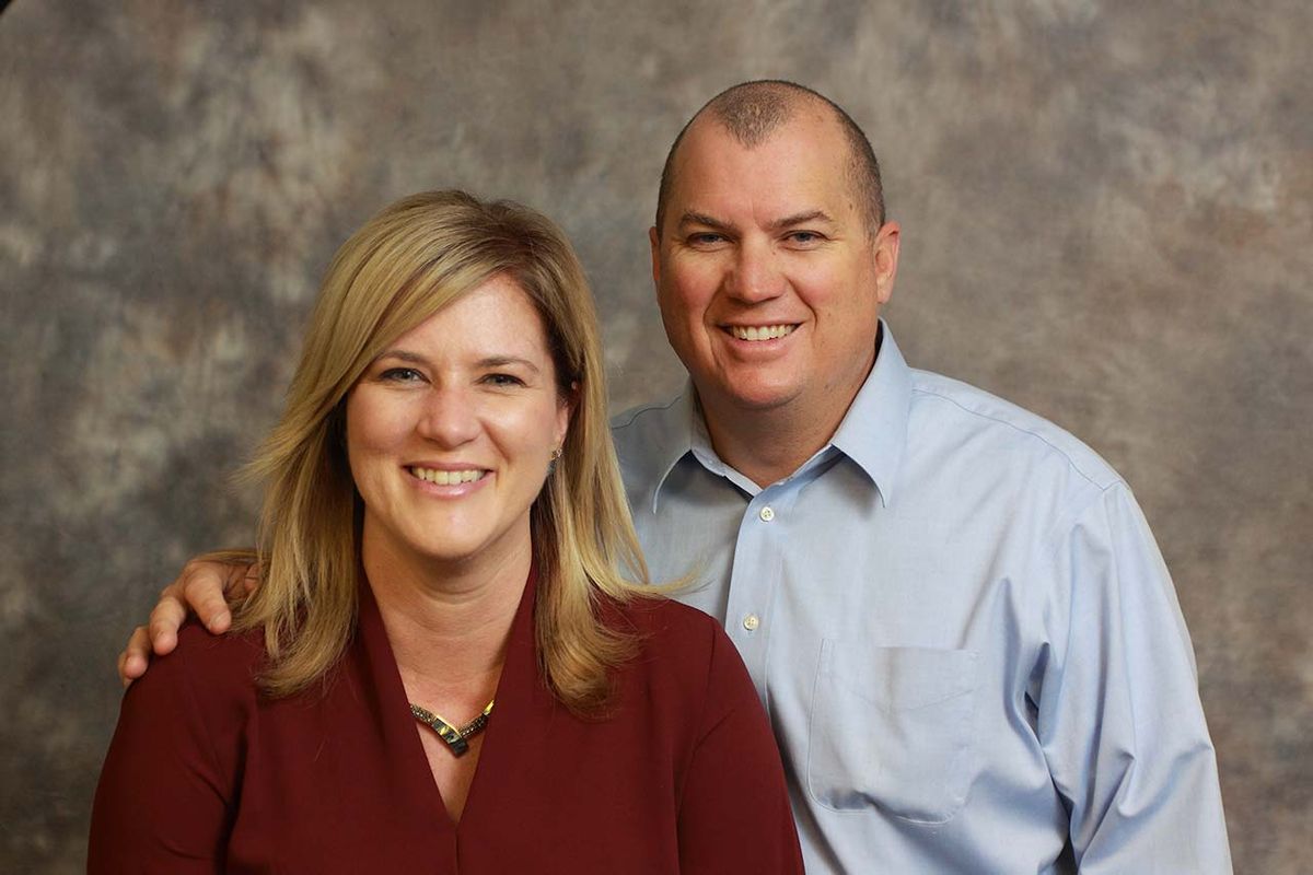 A smiling couple posing for a portrait.