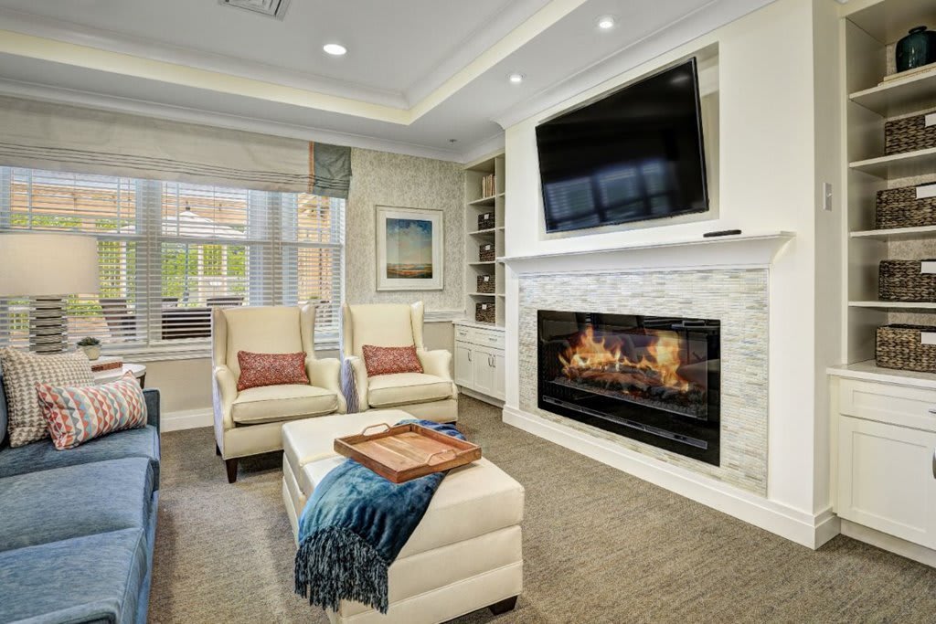 A modern living room featuring a fireplace, television, and comfortable seating area.