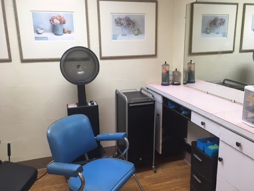 A cozy salon workspace featuring a styling chair and professional equipment.
