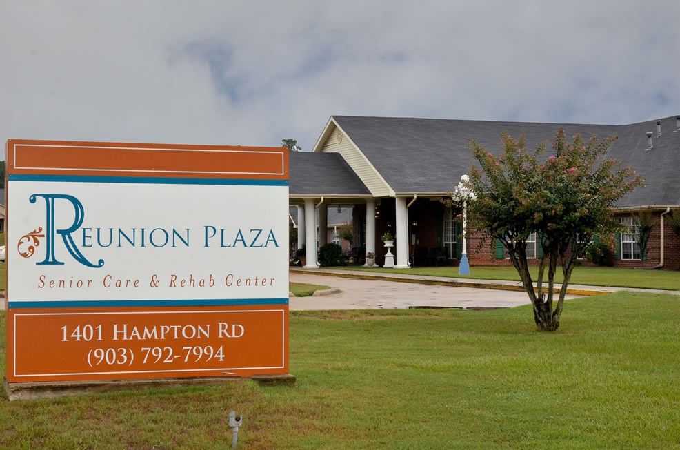 A retirement and rehabilitation center with a large sign in front of the building.