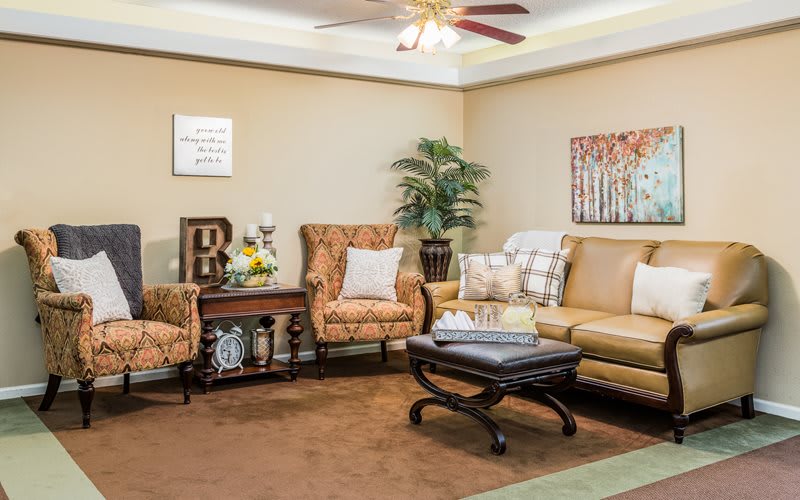 A cozy living room with a sofa, armchairs, and stylish decor.