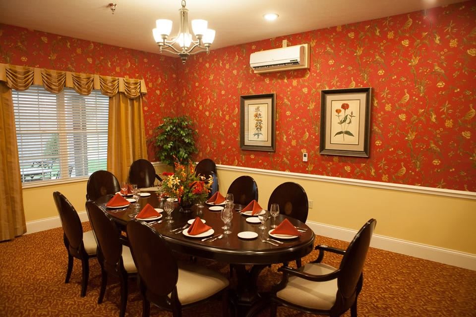 Elegantly decorated dining room with a set table and wall art.